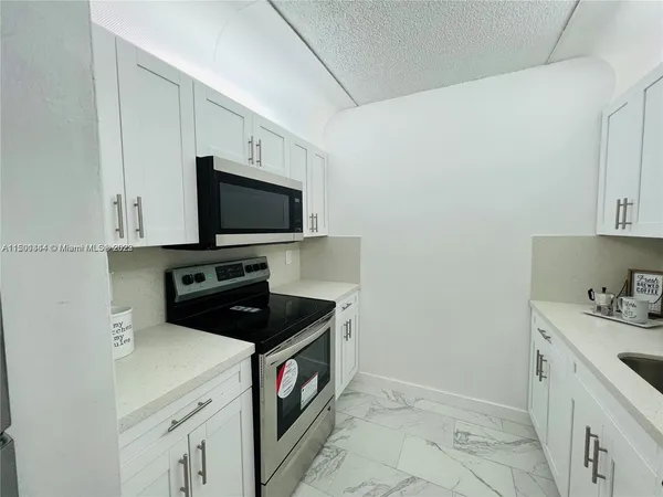 a kitchen with a sink and a stove top oven