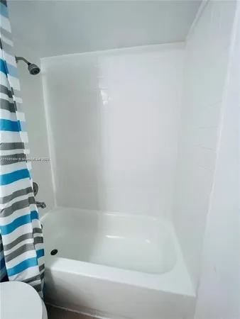 a bathroom with a bathtub and toilet