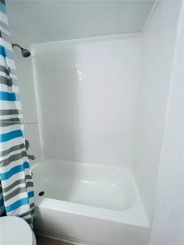 a bathroom with a bathtub and toilet