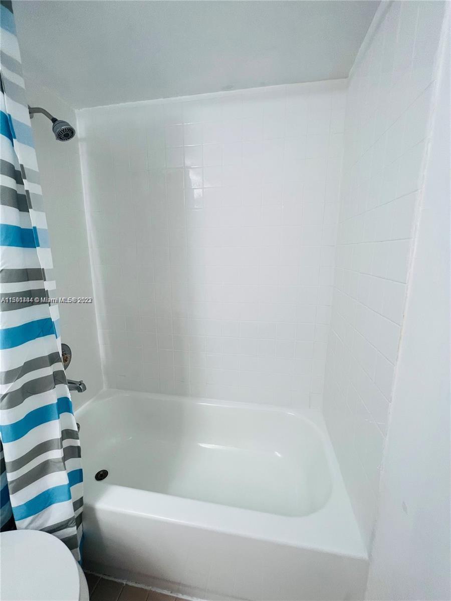 8260 Southwest 210th Street, Unit 220 Cutler Bay, FL 33189 - Photo 9 of 21 a bathroom with a bathtub and toilet