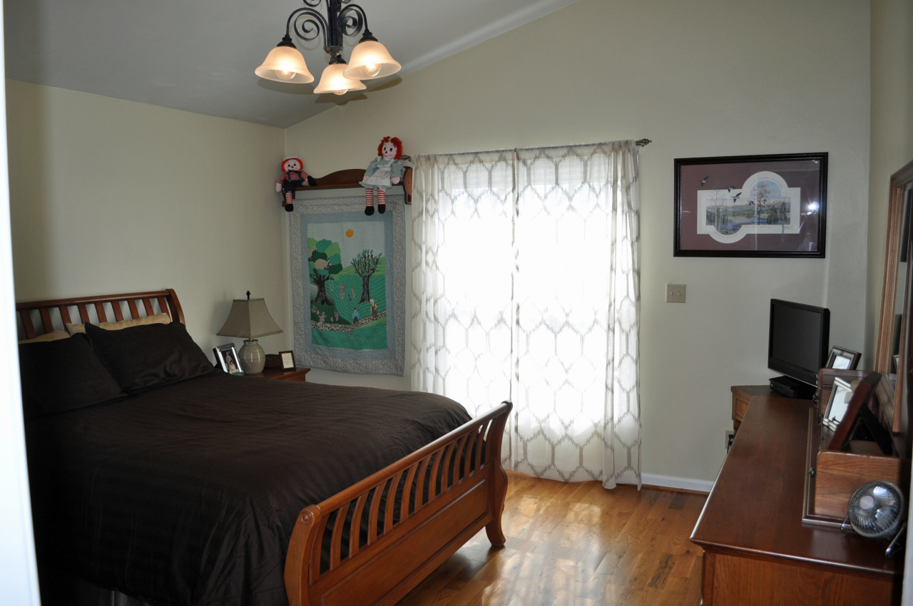 110 Mallard Point Road Wirtz, VA 24184 - Photo 17 of 34 a bedroom with a bed and a flat screen tv