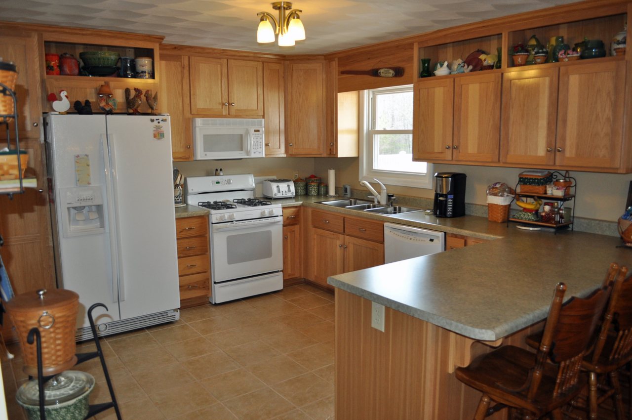 110 Mallard Point Road Wirtz, VA 24184 - Photo 9 of 34 a kitchen with a refrigerator a stove a sink dishwasher and cabinets