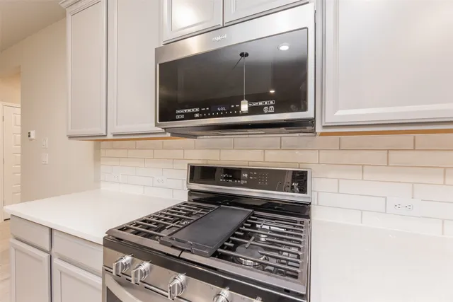 a kitchen with a stove and a microwave
