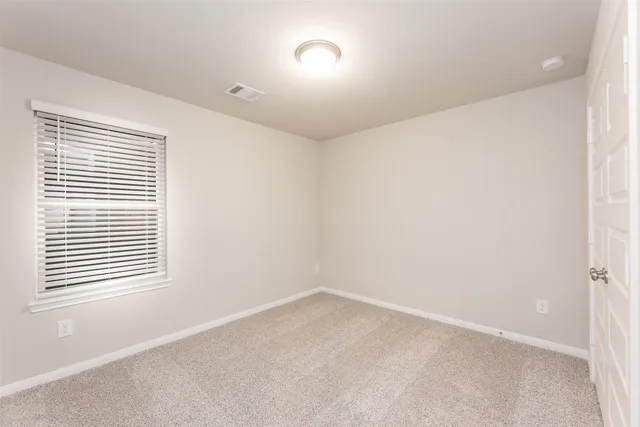 a utility room with a sink a stove and cabinets