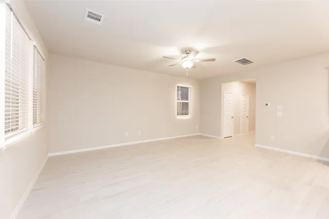 a view of an empty room with a window