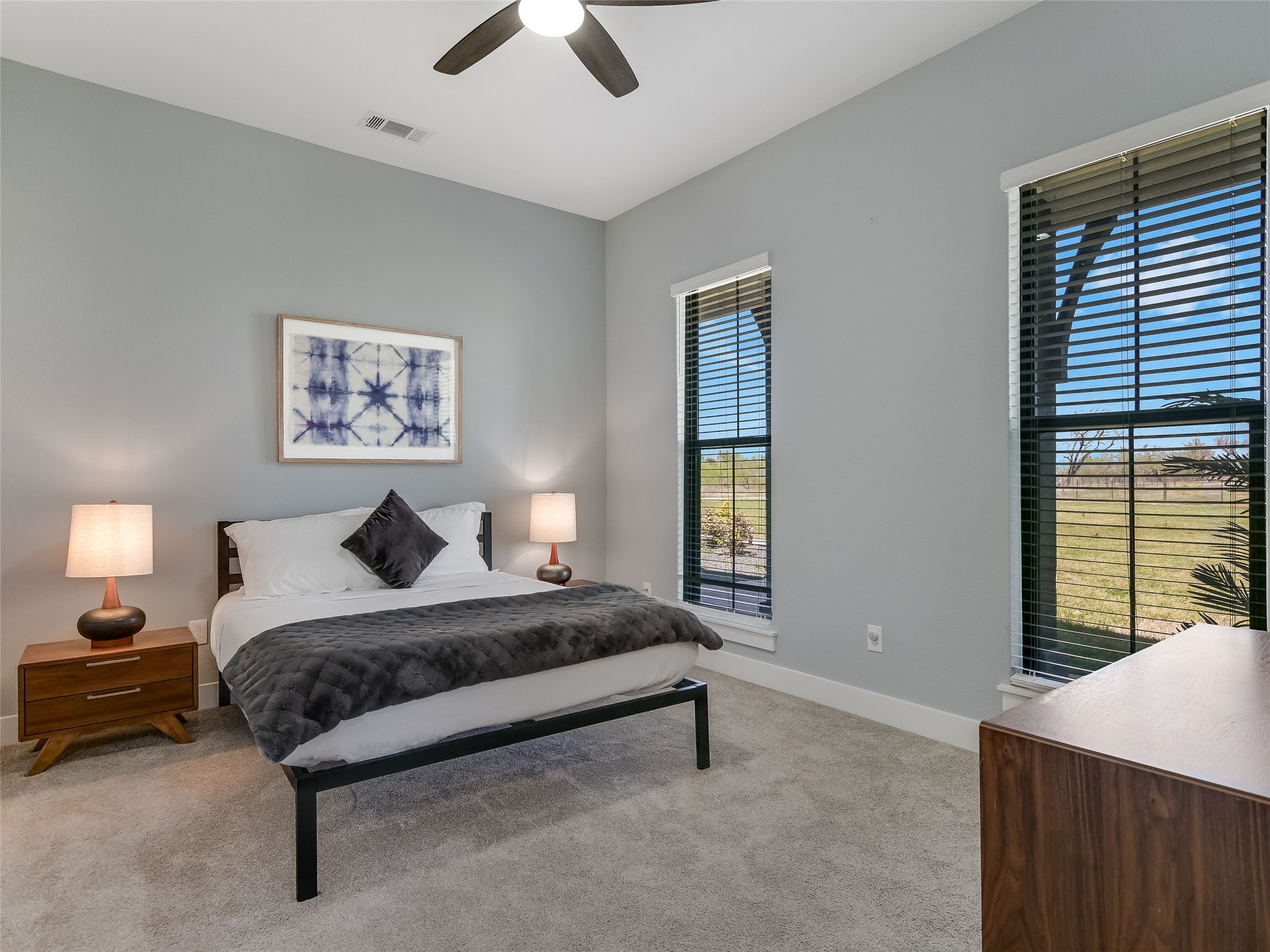 19819 Lockwood Road Manor, TX 78653 - Photo 16 of 29 Oversized windows frame scenic views in this tranquil secondary bedroom, ideal for restful nights or focused remote work.