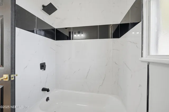 an empty room with floor to ceiling windows and yard