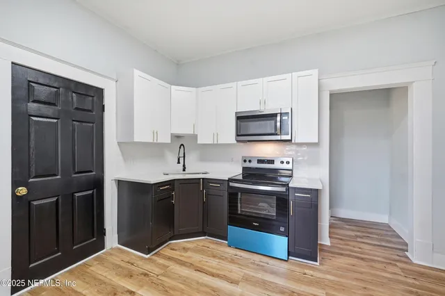 a kitchen with a sink and cabinets