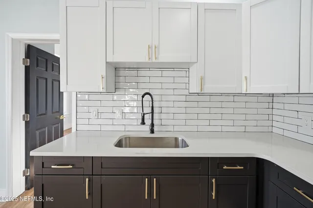 a kitchen with a sink and cabinets