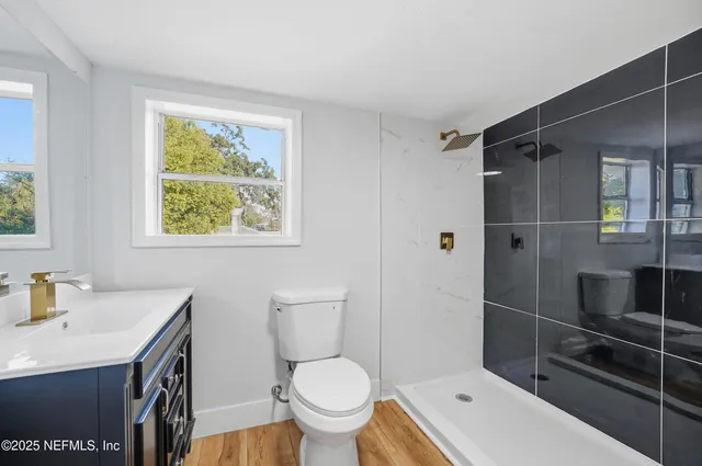 a bathroom with a small yard and a large tree