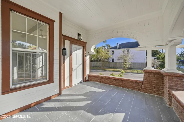 a view of an empty room with a fireplace and a window