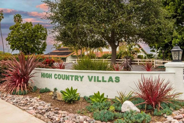 a sign that is in front of flowers