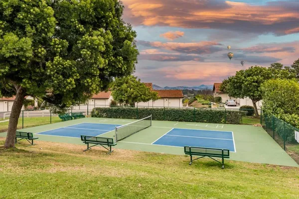 a swimming pool with outdoor seating and trees