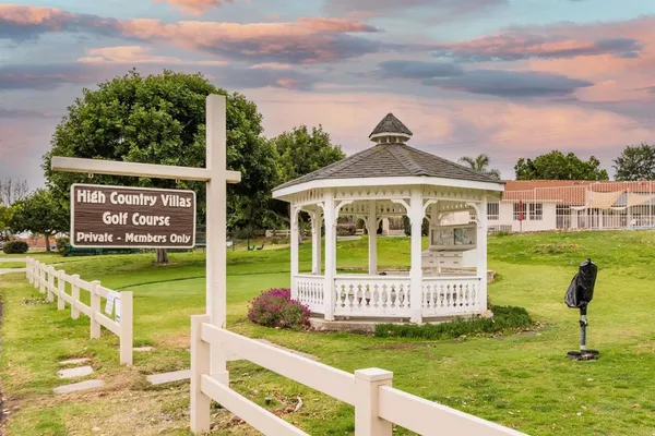 a view of a house with backyard and sitting area
