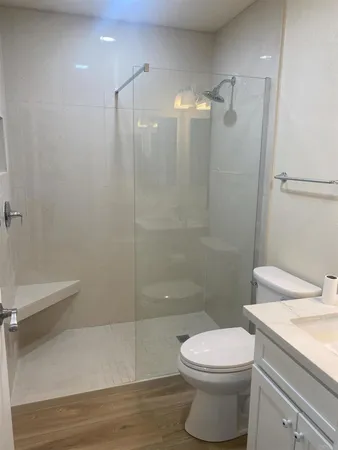 a bathroom with a toilet a sink and shower
