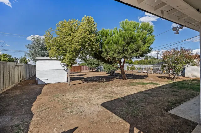 a white house that has a tree in front of it