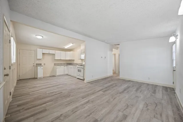 a view of a kitchen with a sink and a refrigerator