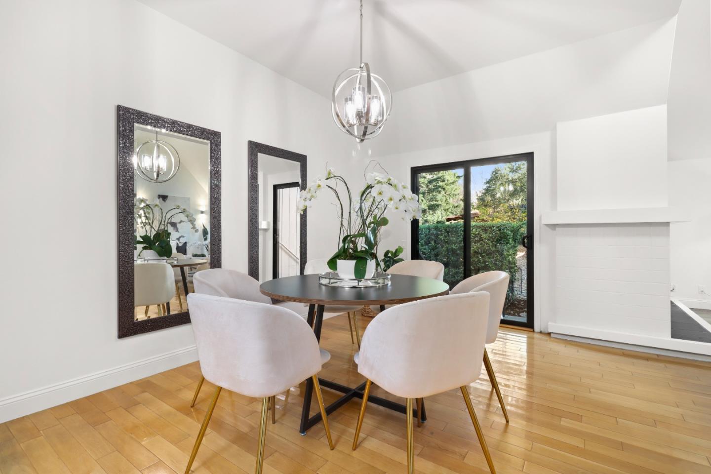 28 Farm Road Los Altos, CA 94024 - Photo 8 of 28 a dining room with wooden floor a chandelier a glass table and chairs