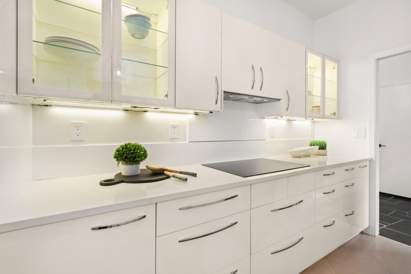 28 Farm Road Los Altos, CA 94024 - Photo 9 of 28 a kitchen with white cabinets and appliances
