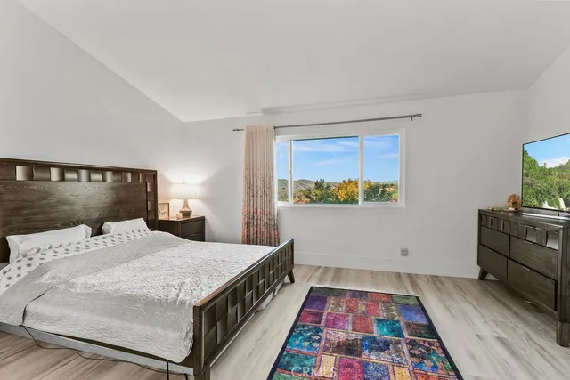 a bedroom with a bed and a view of kitchen