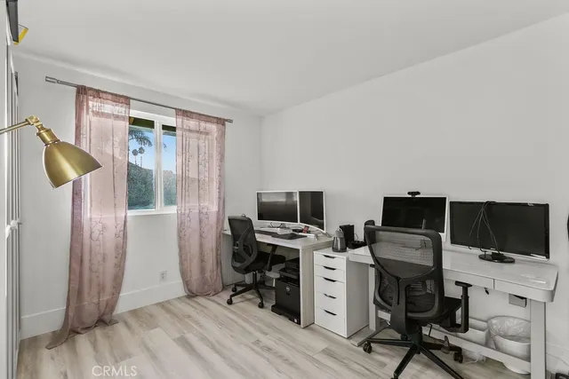 a view of a workspace with furniture and a window