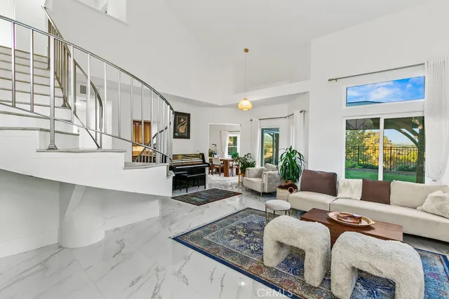 a living room with furniture large window and a table