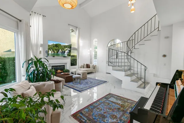 a living room with furniture and a potted plant