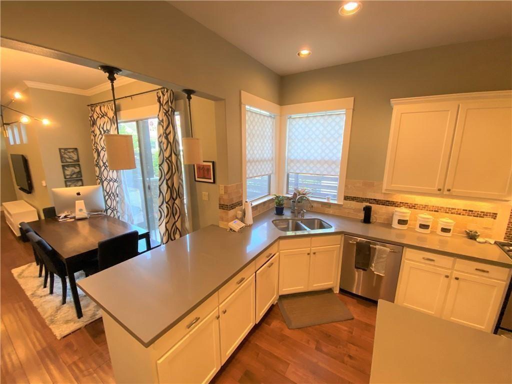 926 East 54th Street, Unit A Austin, TX 78751 - Photo 4 of 8 a kitchen with a sink refrigerator and cabinets
