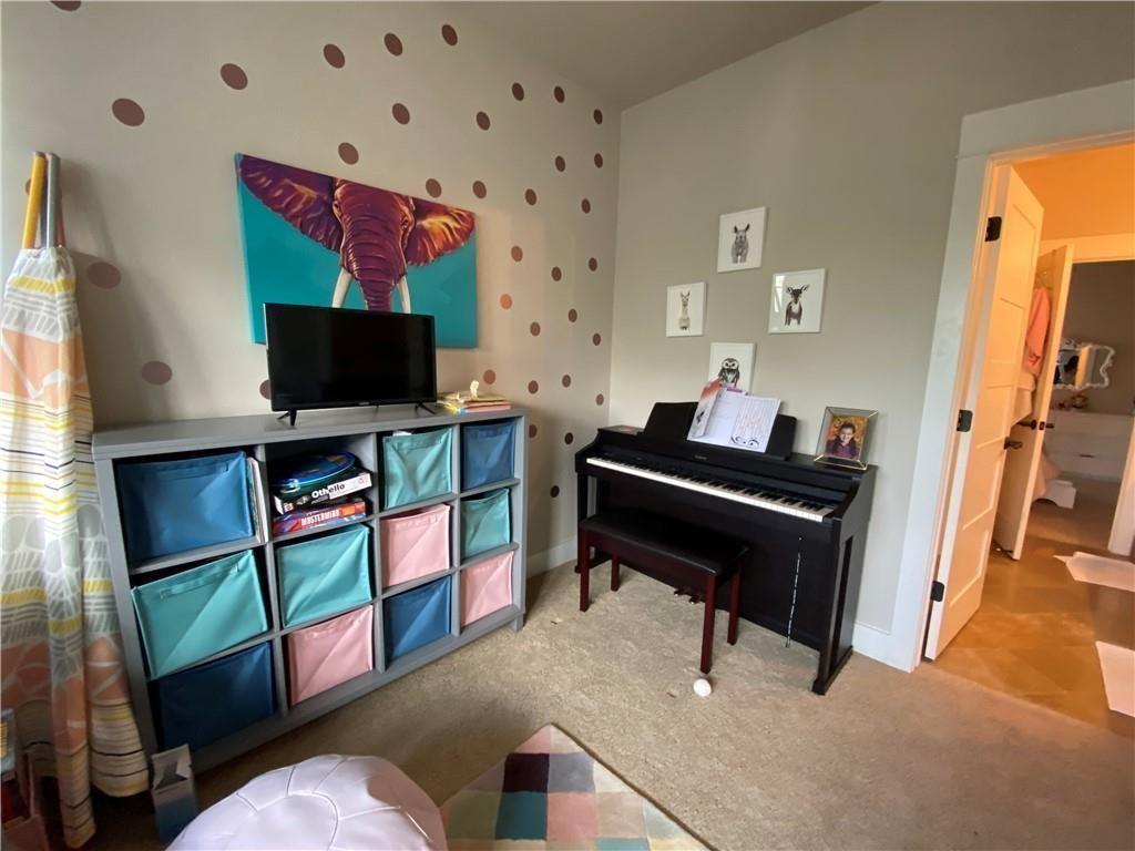 926 East 54th Street, Unit A Austin, TX 78751 - Photo 6 of 8 a living room with furniture and a flat screen tv