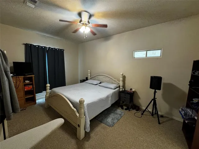 a bedroom with a bed a desk and chair