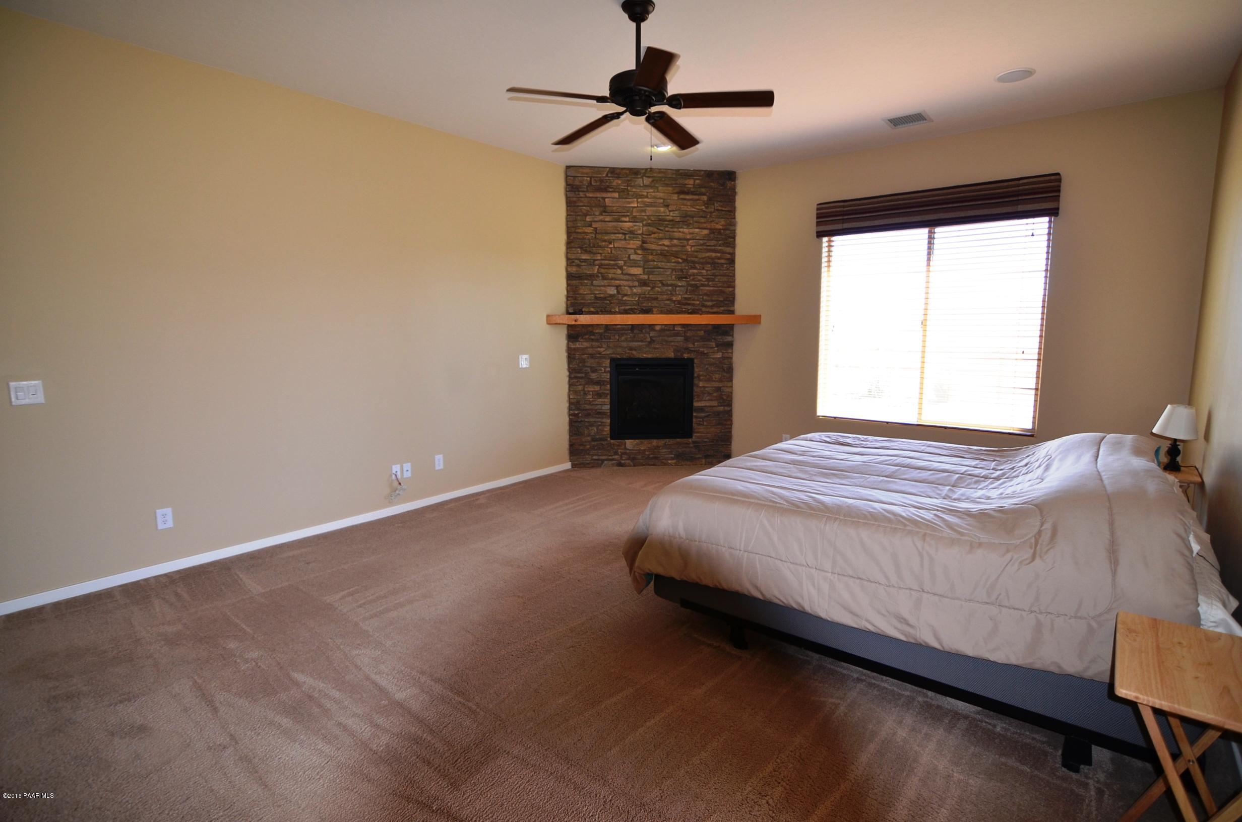 9474 Dows Ranch Road Prescott Valley, AZ 86315 - Photo 11 of 55 a spacious bedroom with a bed and a window