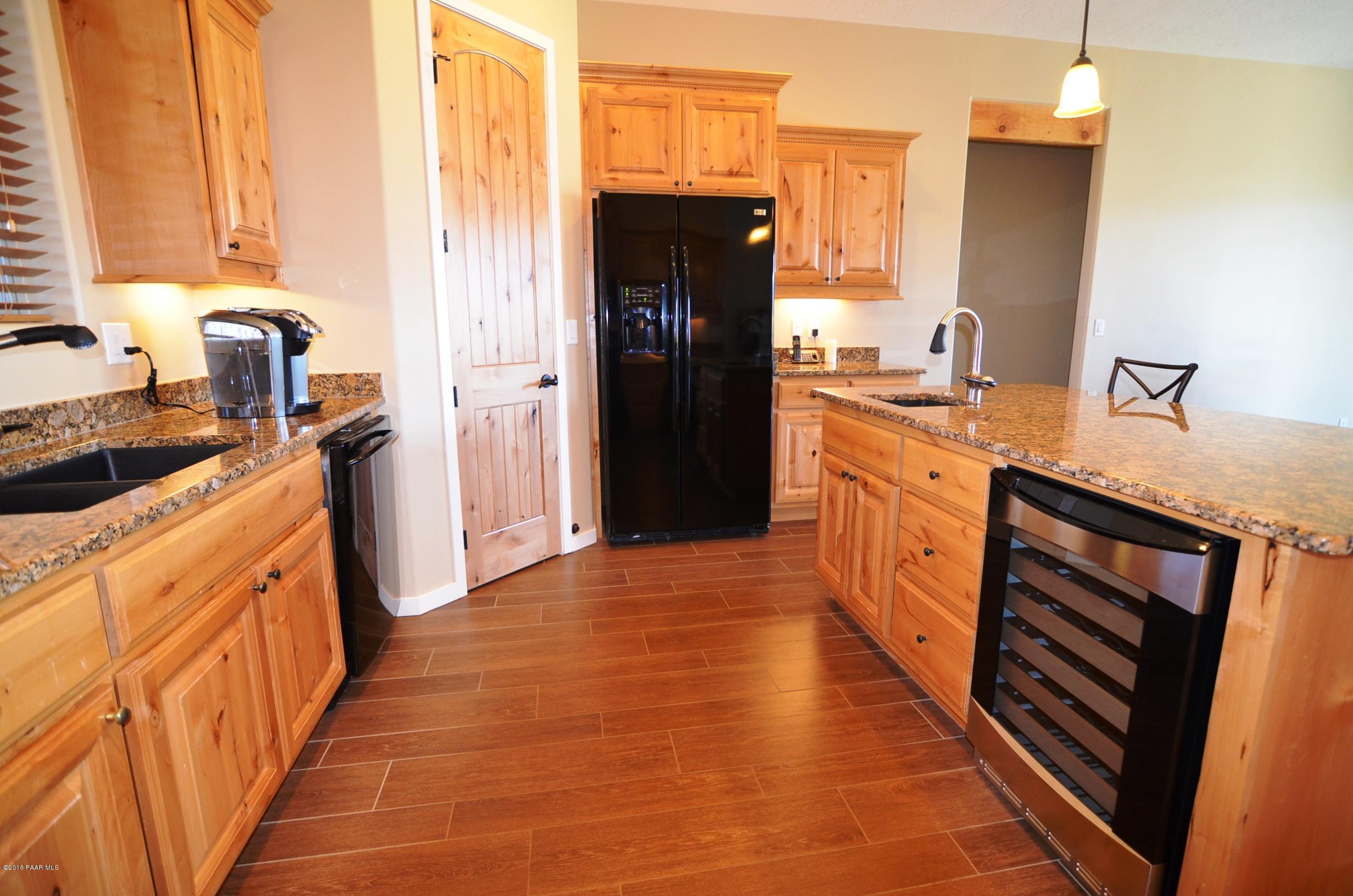 9474 Dows Ranch Road Prescott Valley, AZ 86315 - Photo 36 of 55 a kitchen with stainless steel appliances granite countertop a refrigerator and a stove top oven