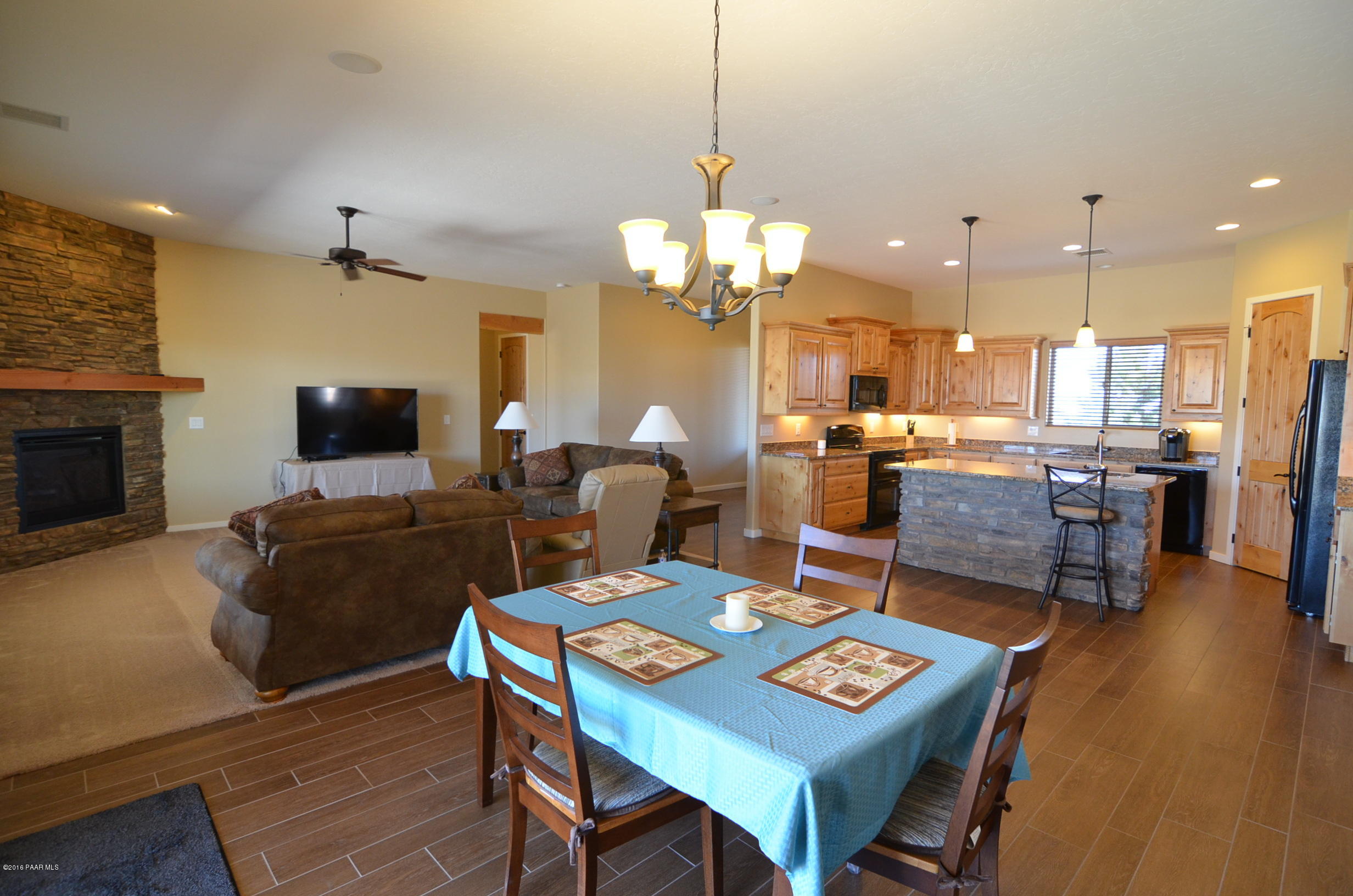 9474 Dows Ranch Road Prescott Valley, AZ 86315 - Photo 43 of 55 a view of a dining room with furniture and wooden floor