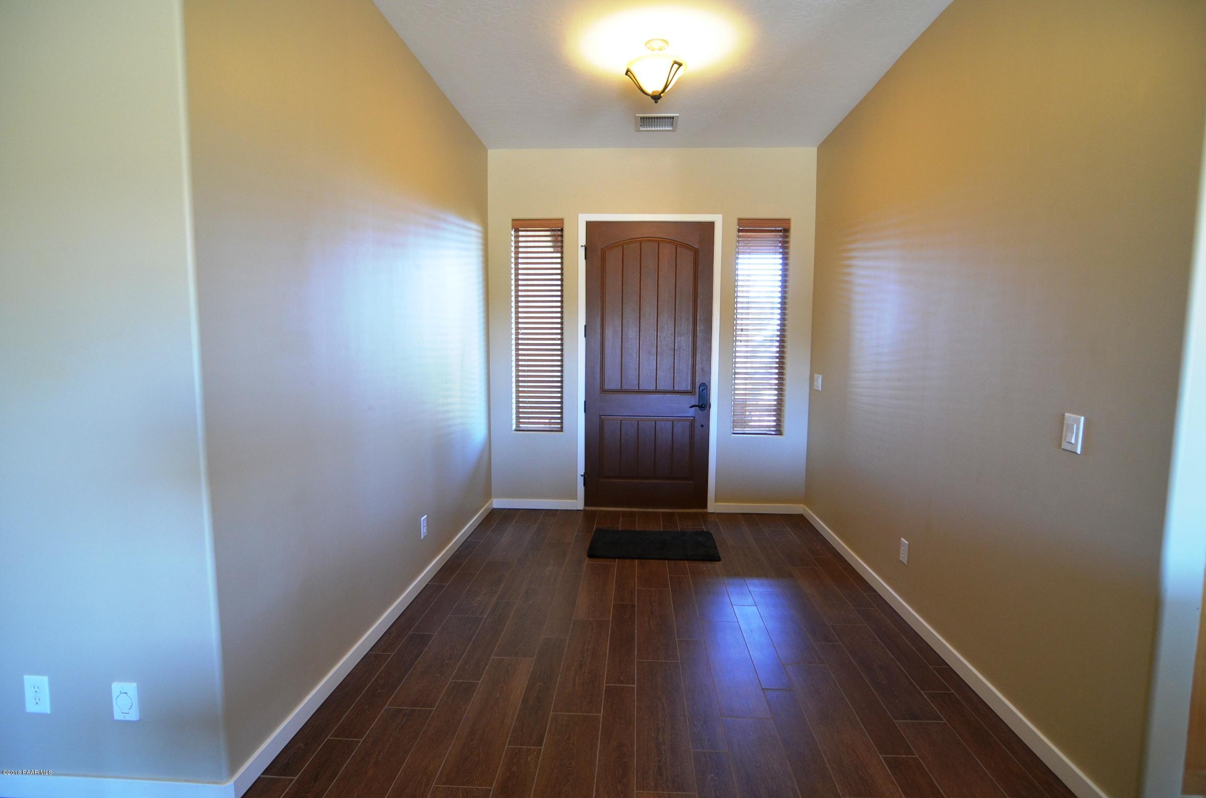 9474 Dows Ranch Road Prescott Valley, AZ 86315 - Photo 46 of 55 a view of an empty room with wooden floor