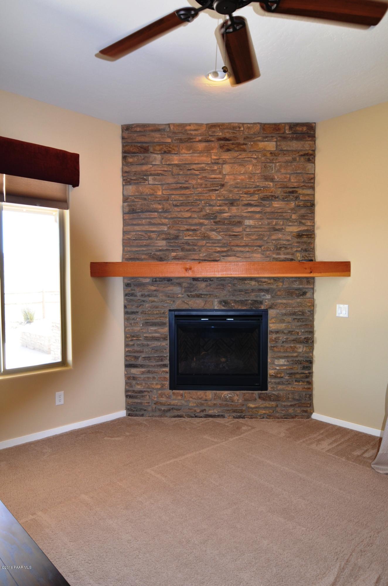 9474 Dows Ranch Road Prescott Valley, AZ 86315 - Photo 47 of 55 a view of living room with a fireplace