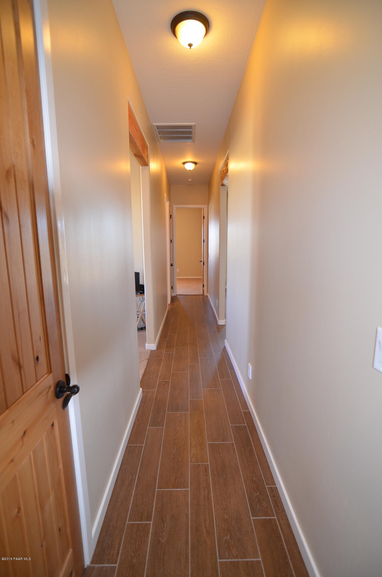 9474 Dows Ranch Road Prescott Valley, AZ 86315 - Photo 49 of 55 a view of a hallway with wooden floor