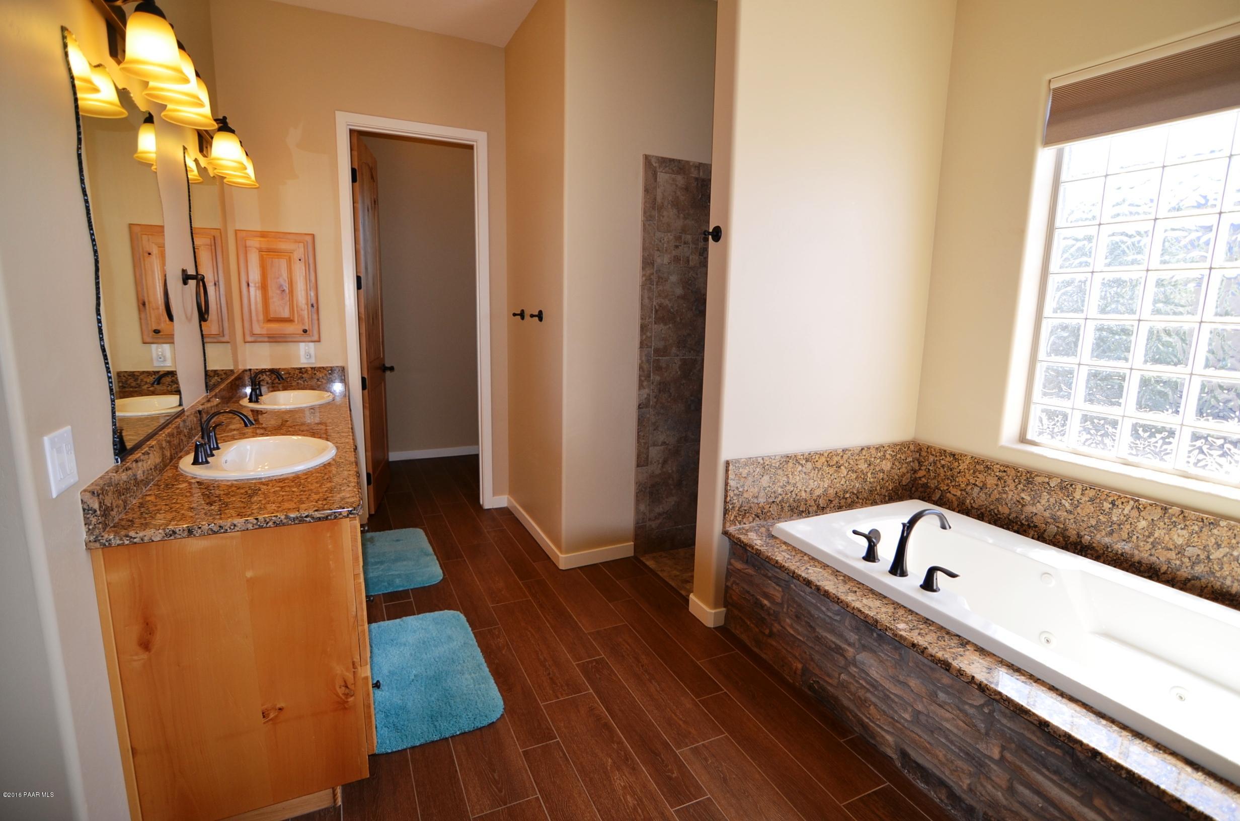 9474 Dows Ranch Road Prescott Valley, AZ 86315 - Photo 5 of 55 a bathroom with a tub sink and mirror