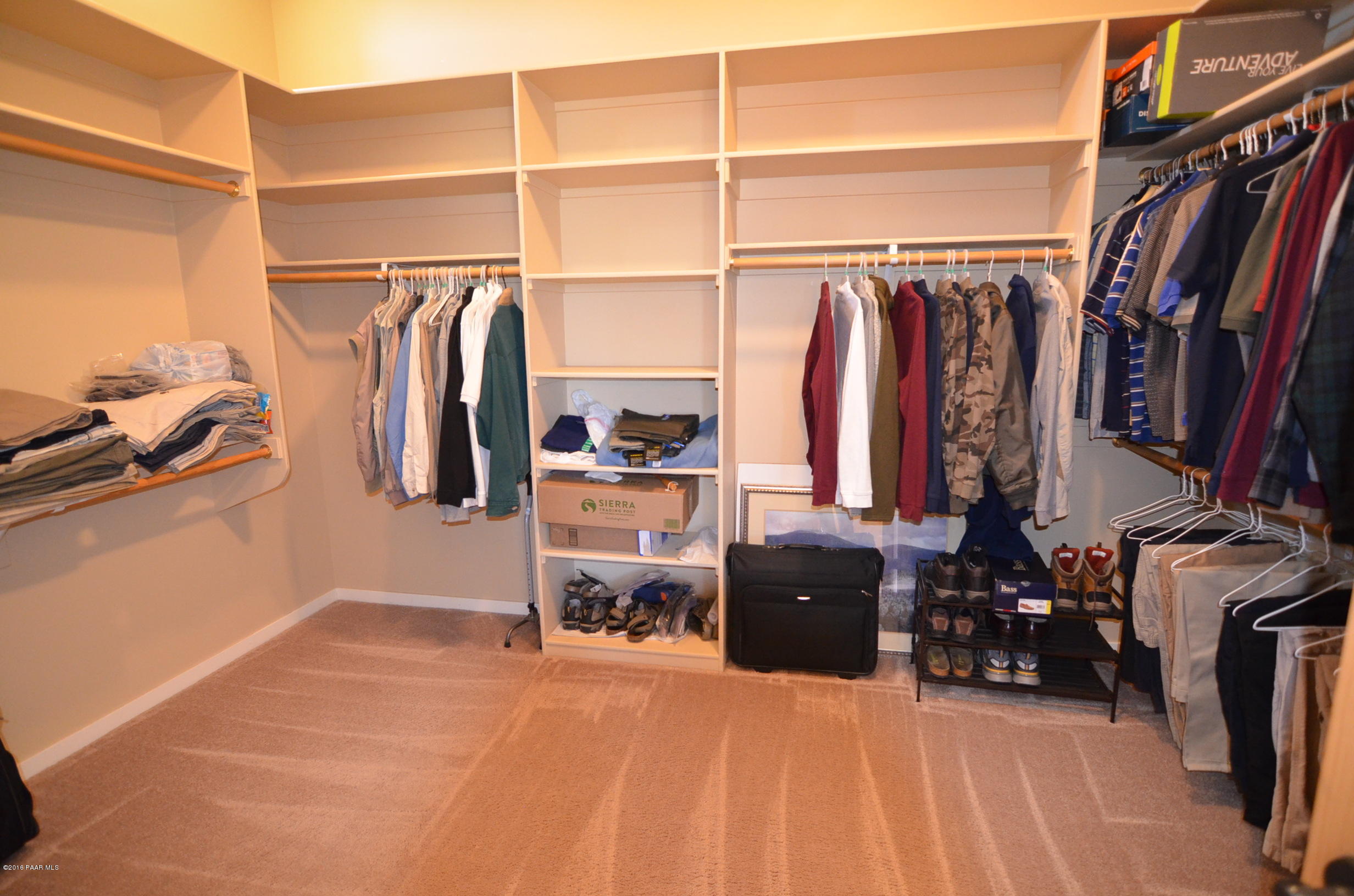 9474 Dows Ranch Road Prescott Valley, AZ 86315 - Photo 53 of 55 a view of walk in closet with clothes and shoes