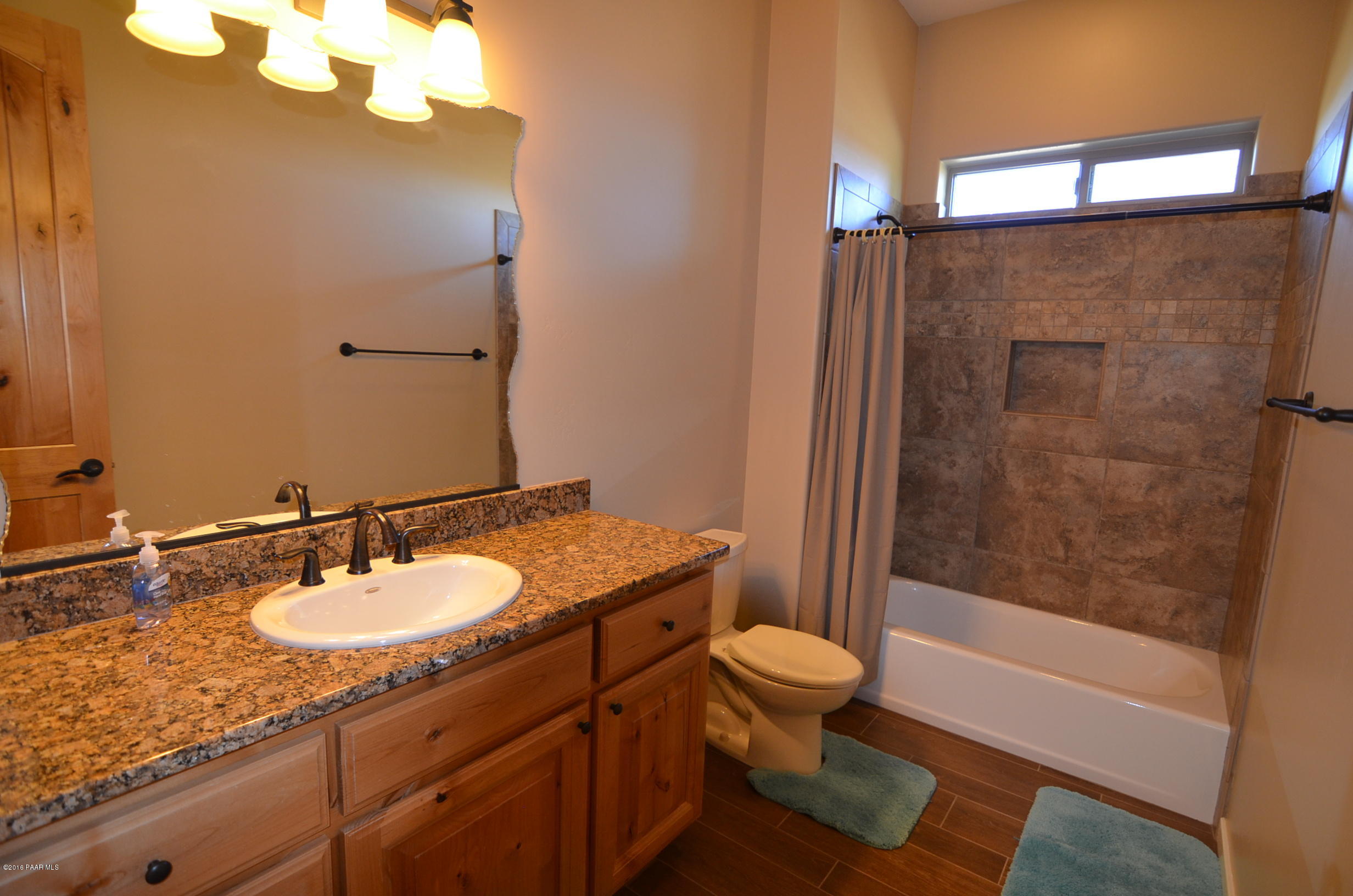 9474 Dows Ranch Road Prescott Valley, AZ 86315 - Photo 9 of 55 a bathroom with a granite countertop sink toilet and shower
