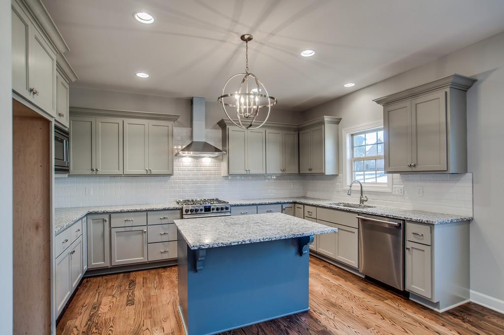 7314 Allans Ridge Lane Fairview, TN 37062 - Photo 13 of 30 a kitchen with granite countertop a sink stainless steel appliances and cabinets