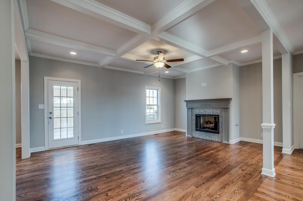 7314 Allans Ridge Lane Fairview, TN 37062 - Photo 6 of 30 an empty room with wooden floor fireplace and windows