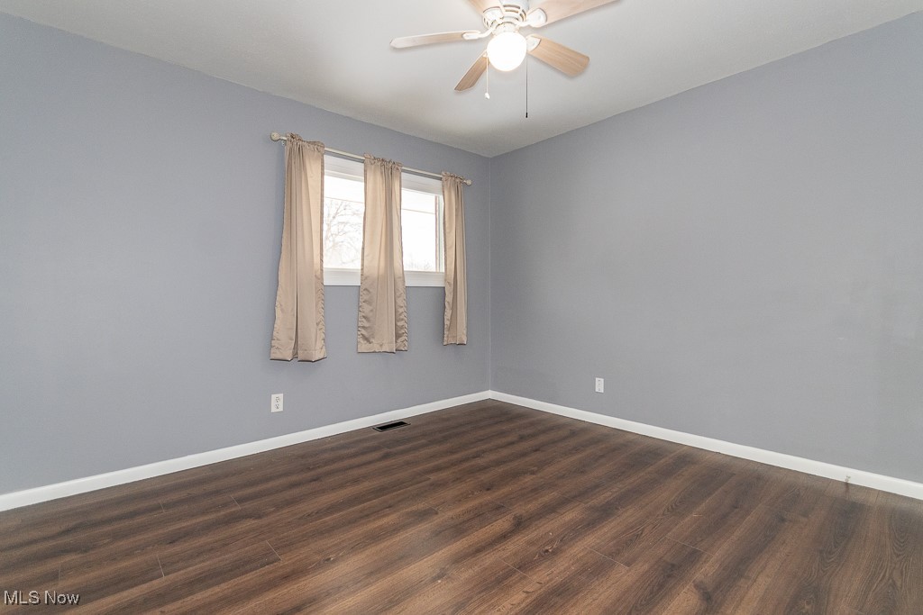 7996 Munson Road Mentor, OH 44060 - Photo 22 of 33 Unfurnished room featuring ceiling fan and dark hardwood / wood-style flooring