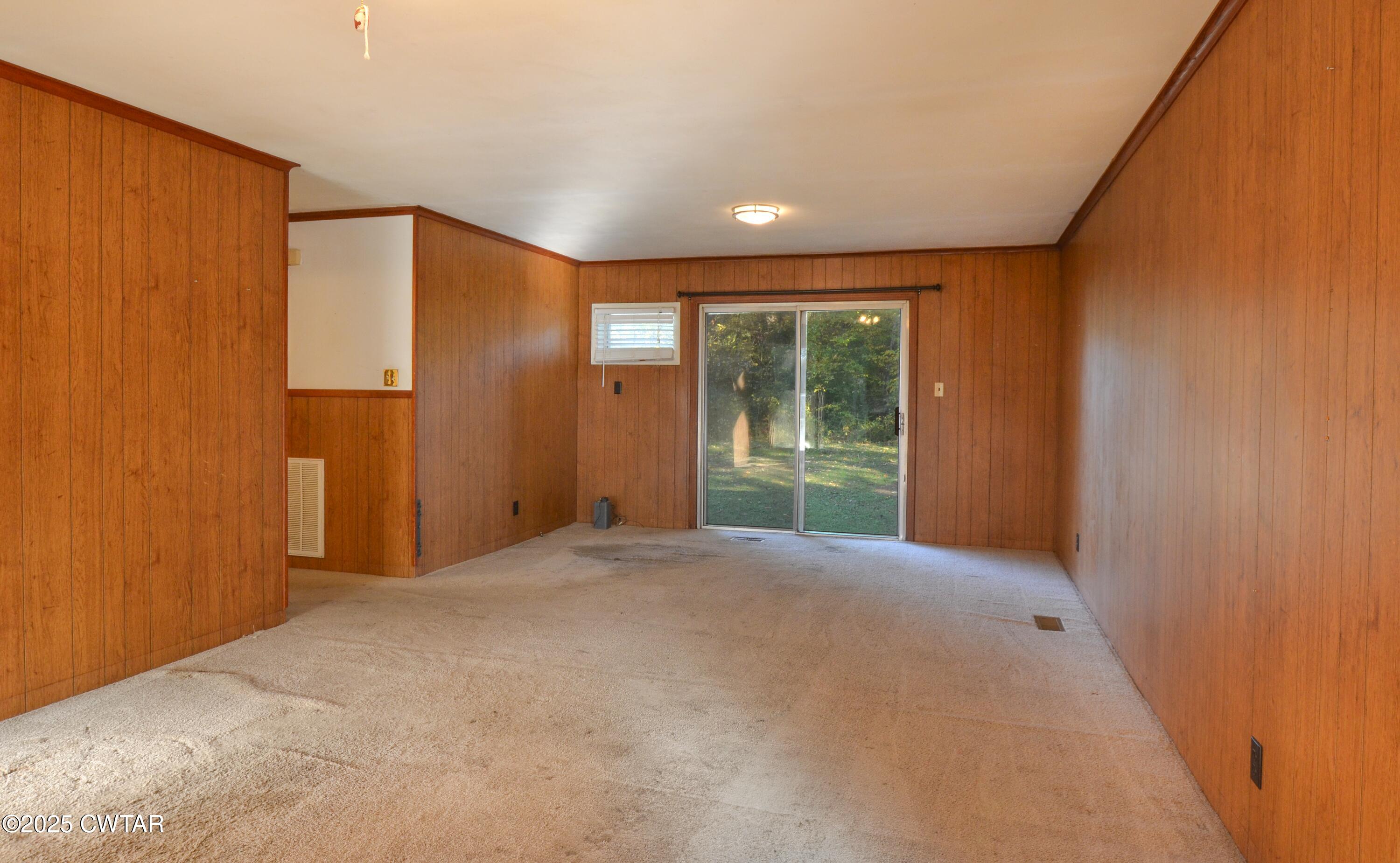 123 Sunset Drive Bells, TN 38006 - Photo 13 of 23 a view of an empty room with wooden floor and a window
