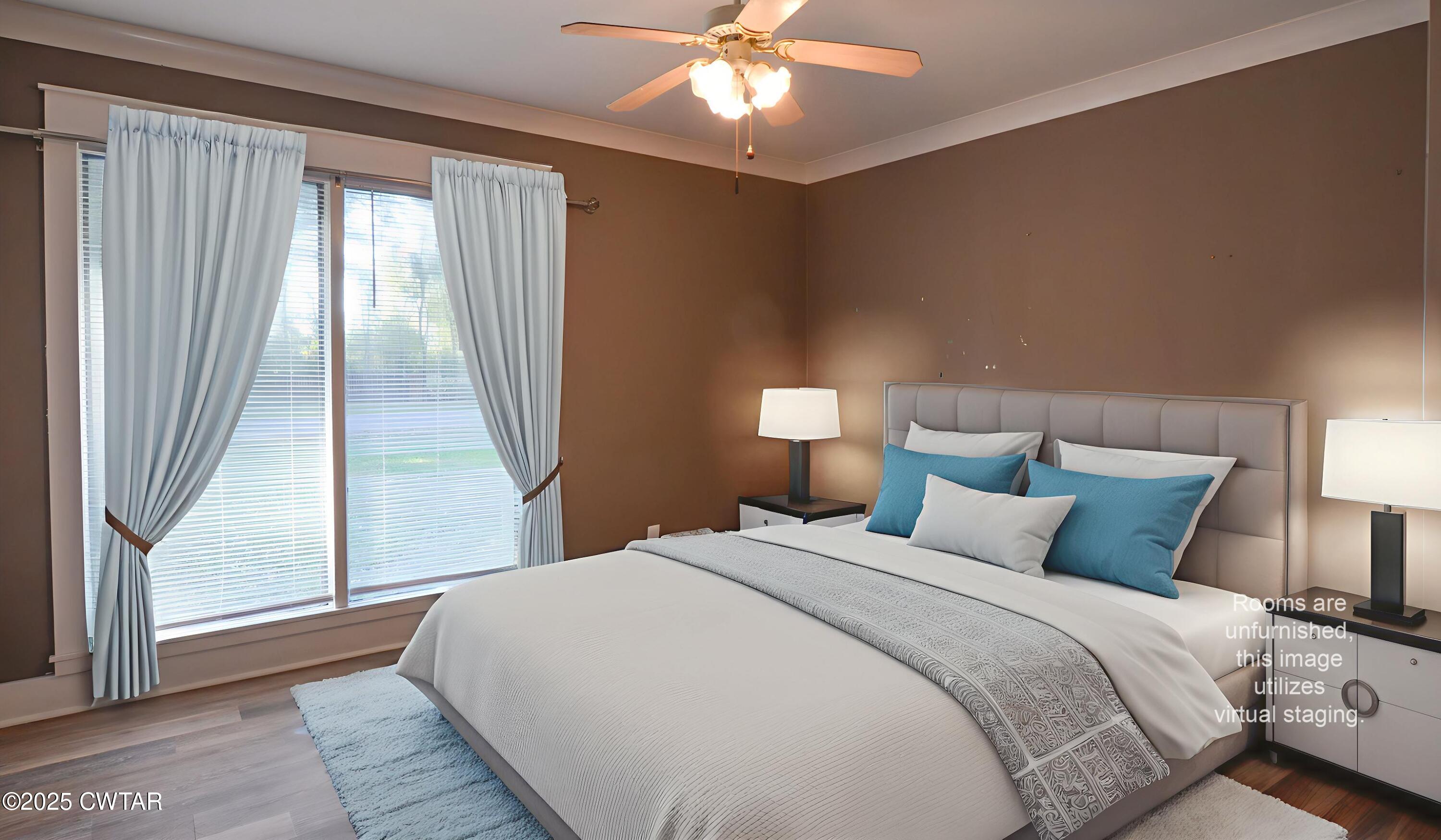 123 Sunset Drive Bells, TN 38006 - Photo 16 of 23 a bedroom with a large bed and a large window