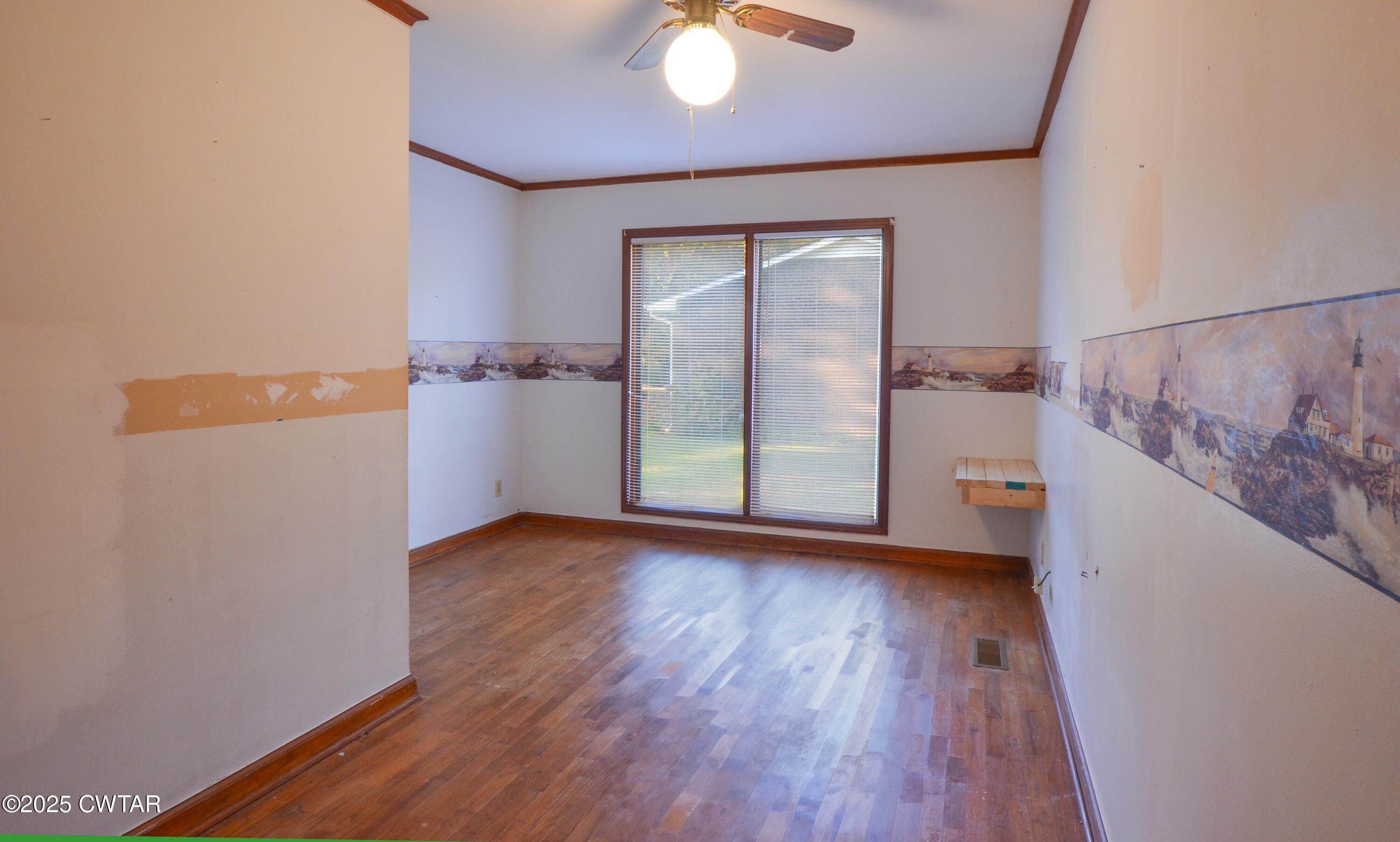 123 Sunset Drive Bells, TN 38006 - Photo 17 of 23 an empty room with wooden floor and windows