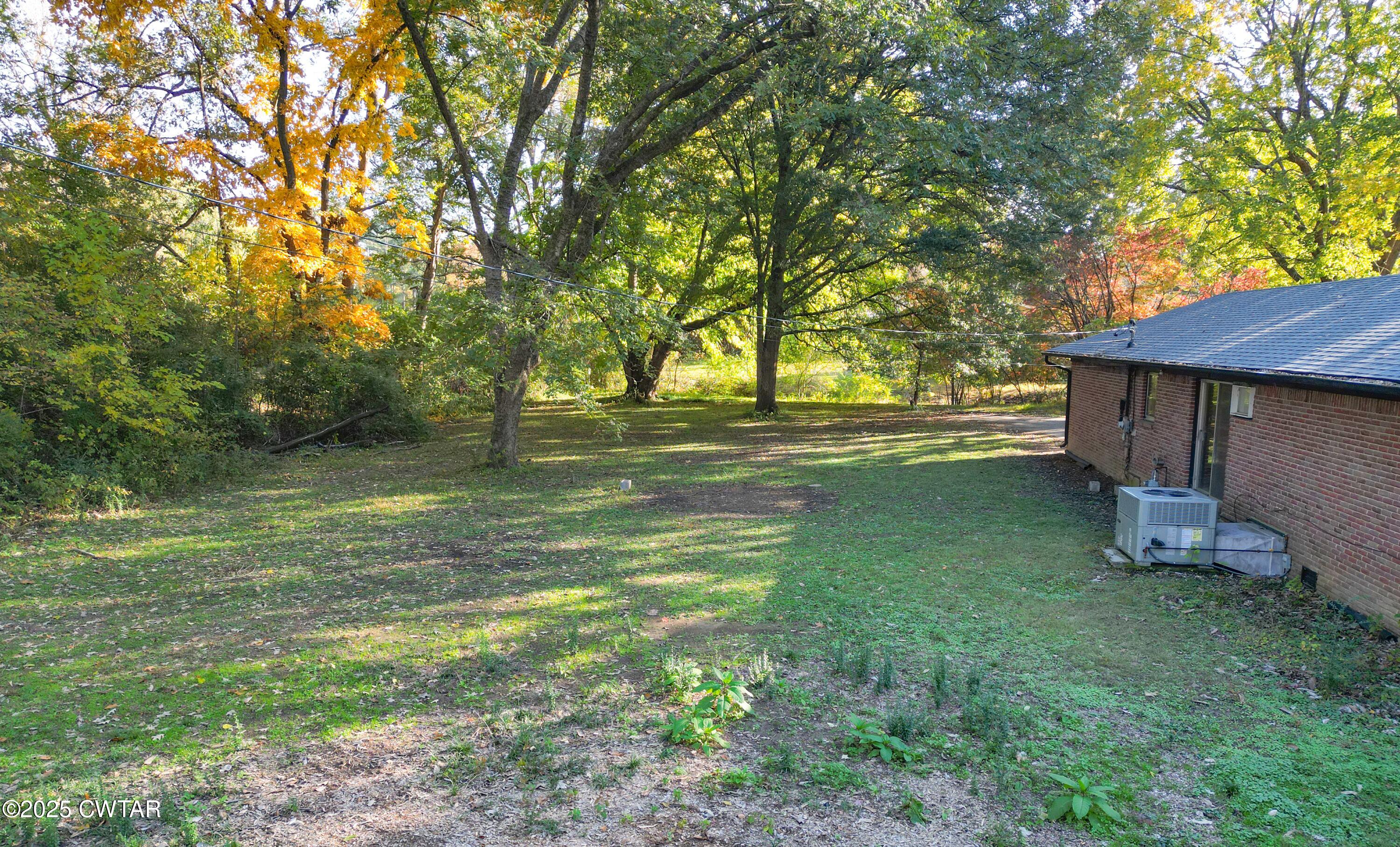 123 Sunset Drive Bells, TN 38006 - Photo 3 of 23 a view of a backyard with a garden