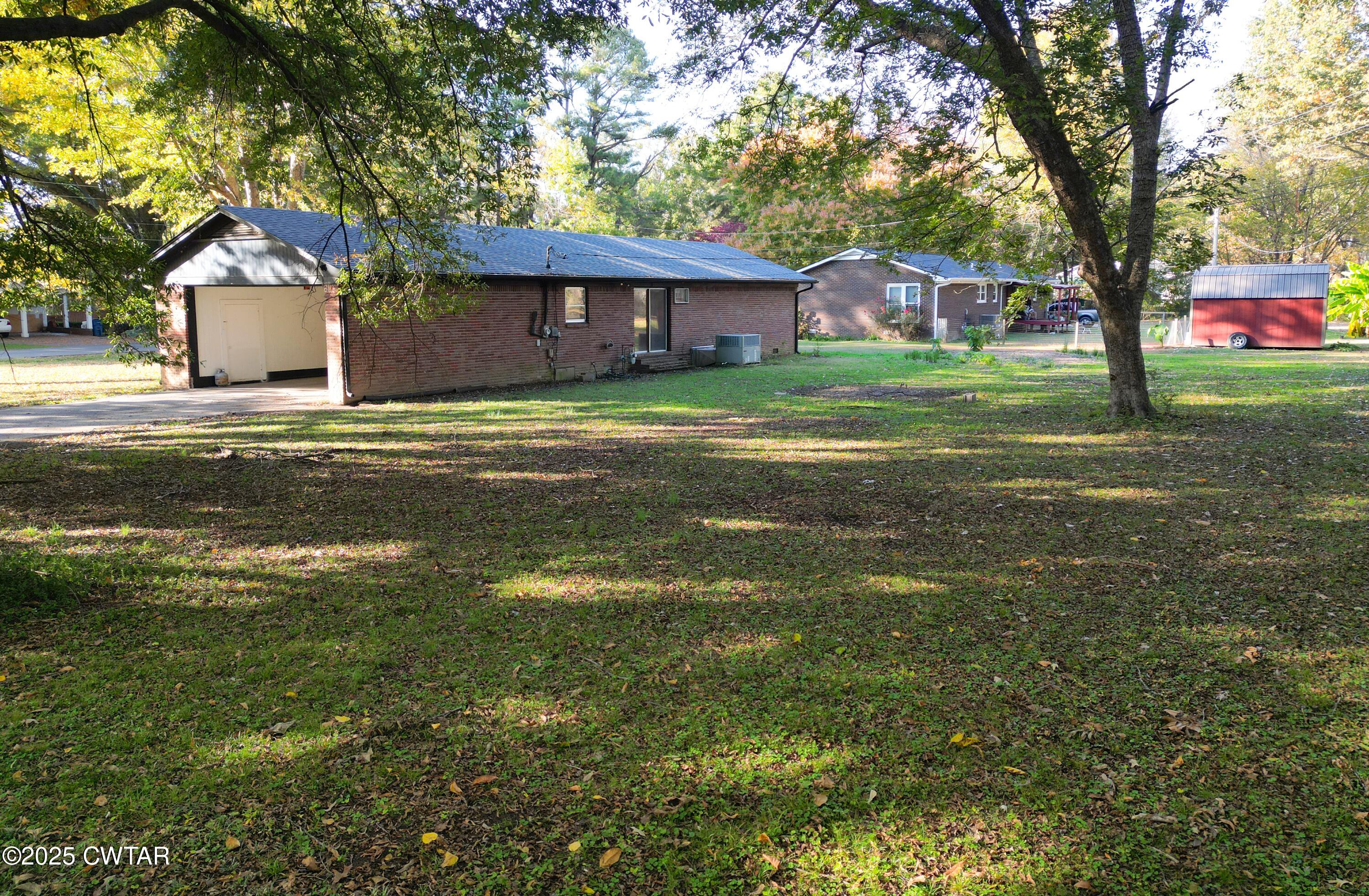 123 Sunset Drive Bells, TN 38006 - Photo 6 of 23 a front view of a house with a garden