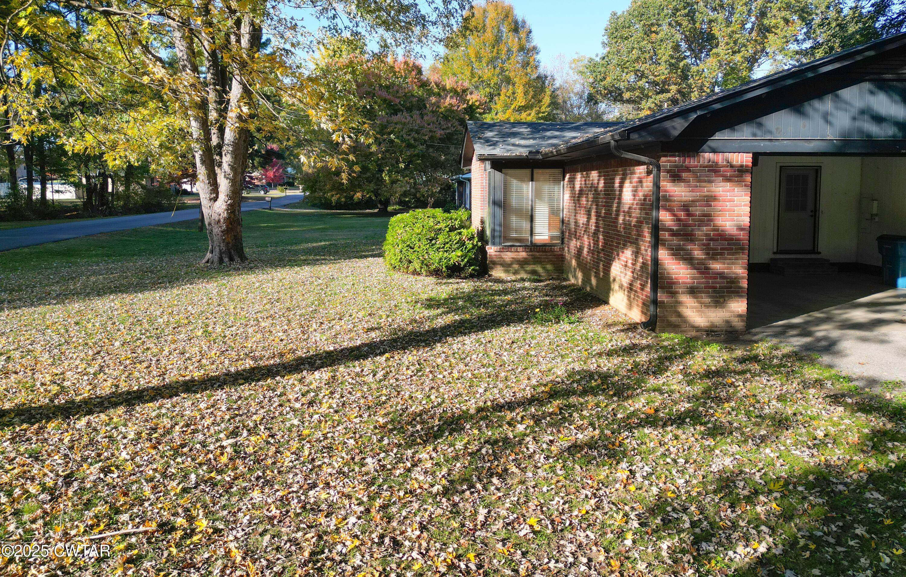 123 Sunset Drive Bells, TN 38006 - Photo 7 of 23 a view of a barn house next to a yard with large trees