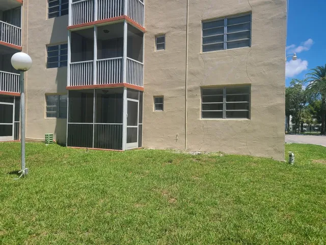 a view of an house with backyard space and balcony