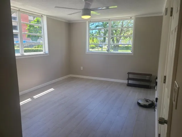 a view of workspace with wooden floor and window